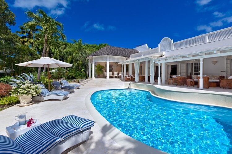 A luxury villa with a swimming pool and seating area