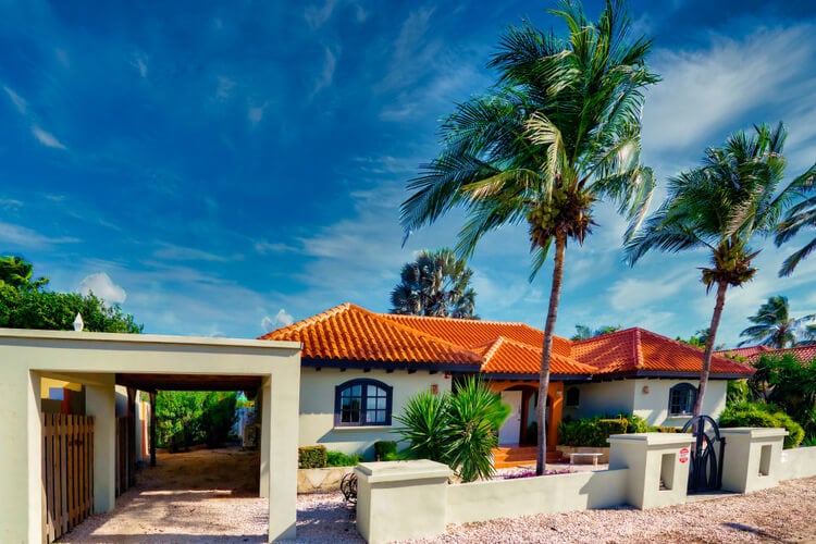 Traditional Aruba villa with palm trees