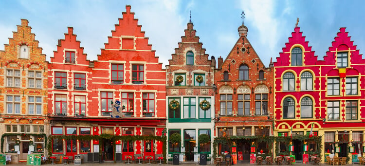 Traditional Bruges building decorated with Christmas wreaths
