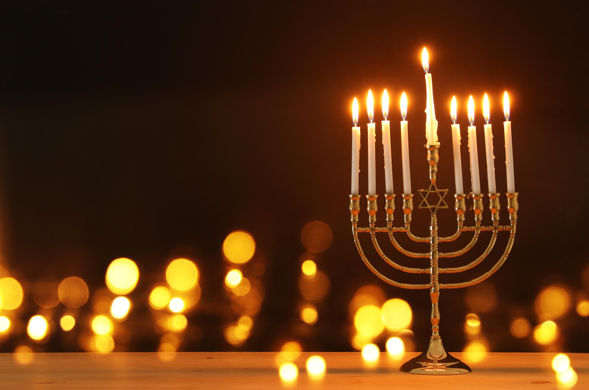 Jewish candles on a table against a dark background