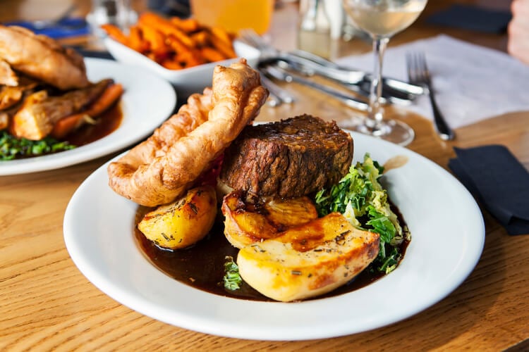 A vegetarian roast dinner featuring nut roast, potatoes, vegetables and Yorkshire pudding