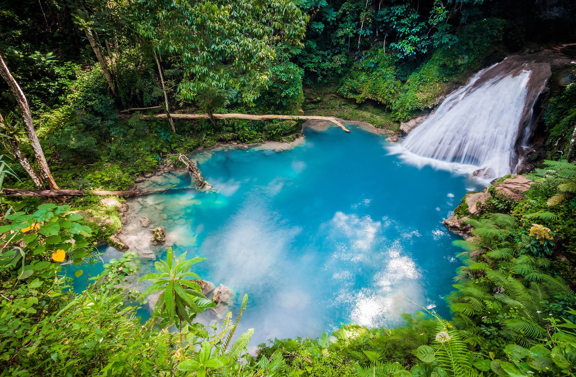 Waterfall into blue lake in Jamaica