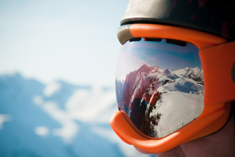 Mountains reflected in ski goggles