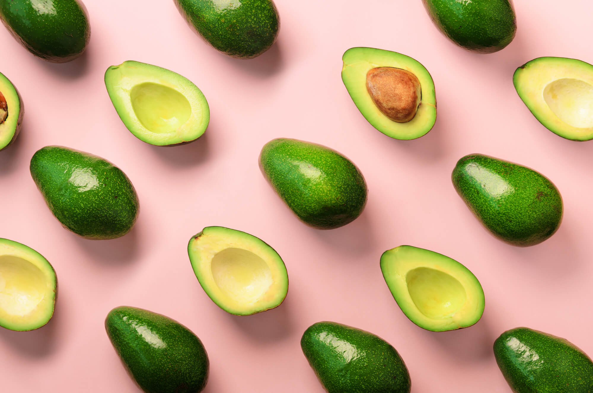 Avocados on a pink background