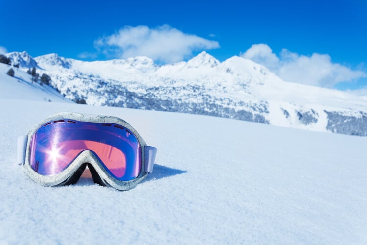 A pair of ski goggles in the snow