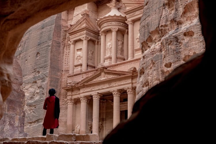 A woman looks at the Treasury in Petra
