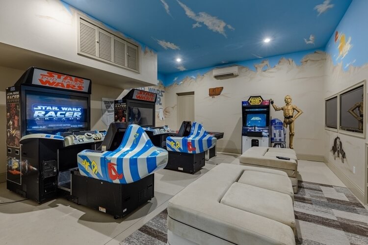 A Star Wars inspired games room with arcade machines and decals on the wall