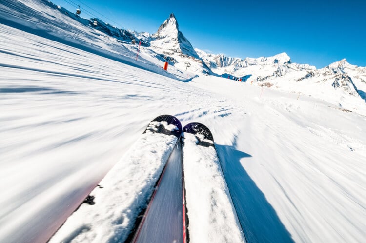 A POV shot of a skier on a snowy mountain