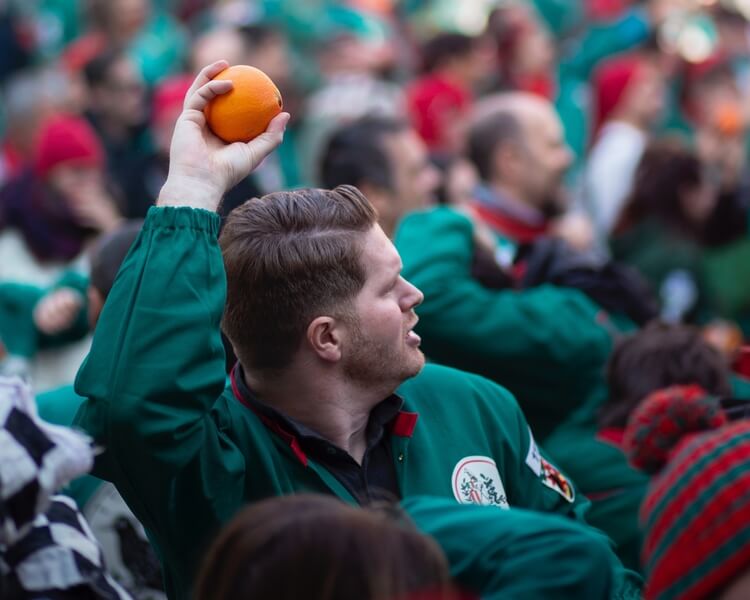 A man getting ready to throw an orange