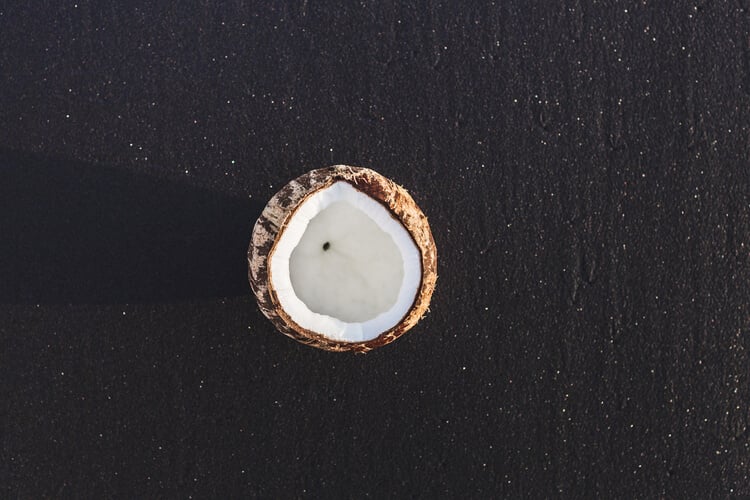 Coconut on the black sand on Keramas Beach