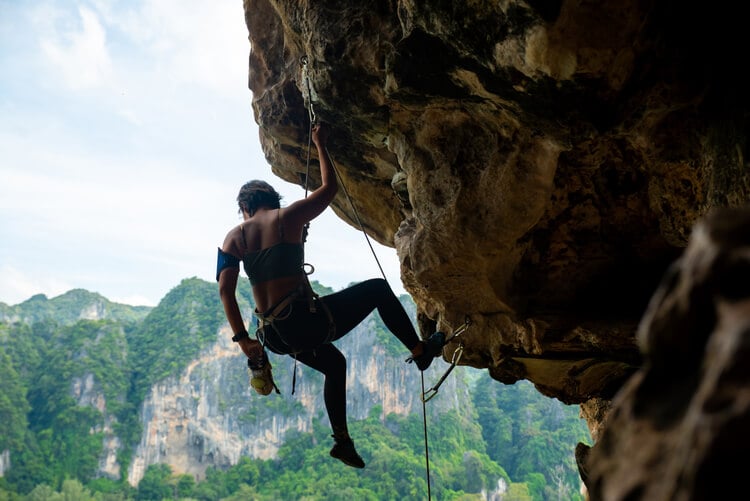 A lady rock climbing in Krabi, Thailand