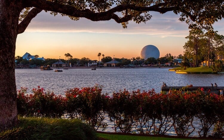 the disney park epcot at disney world orlando, during sunset with water in foreground