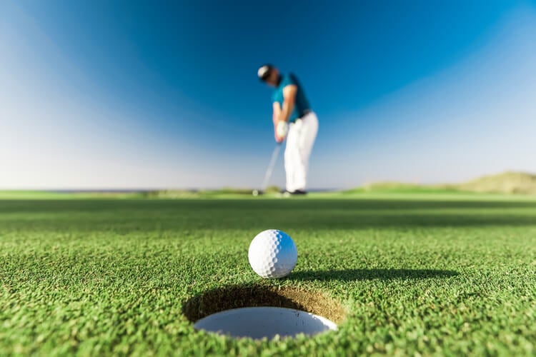 A golf ball approaching a hole