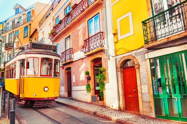 yellow tram on colorful lisbon street