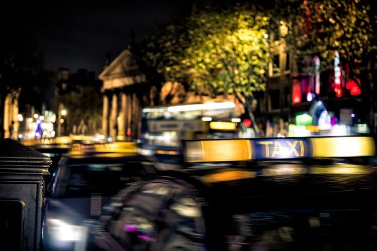 a blurred taxi sign