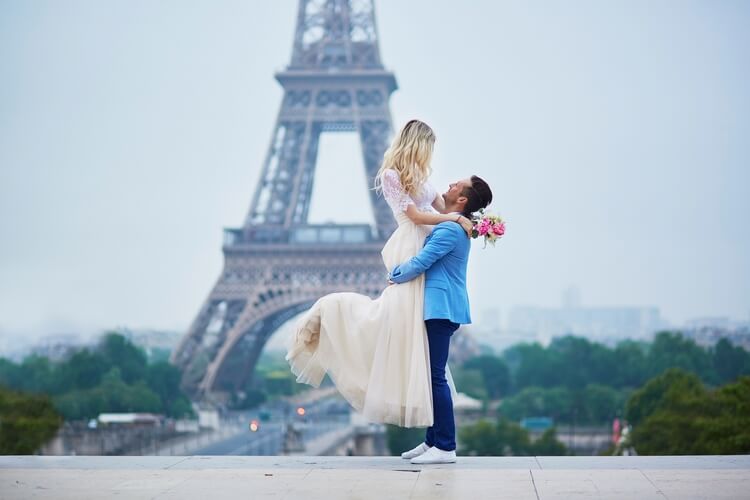 just married man and woman in front of eiffel tower