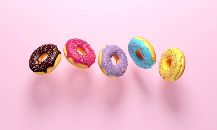 Iced donuts on a pink background