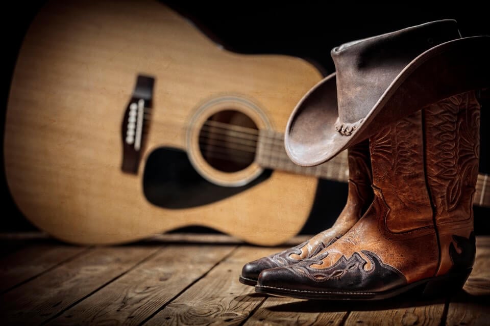 Guitar, boots and a hat