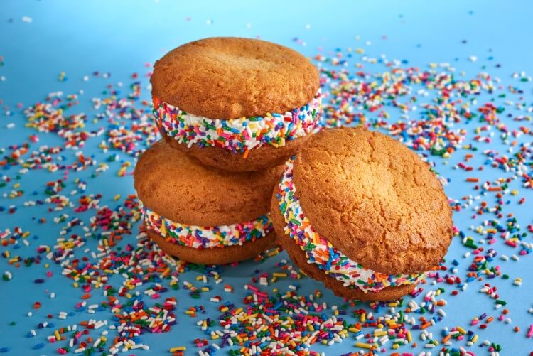 An ice cream sandwich with rainbow sprinkles