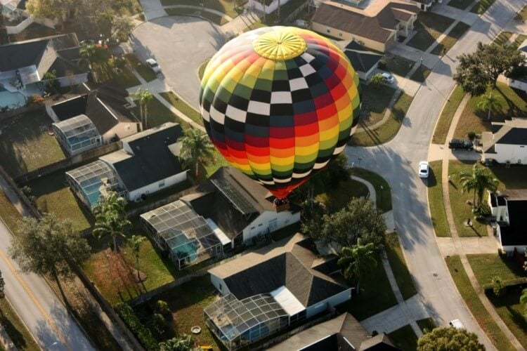 Hot air balloon drifting over villas in Orlando. 