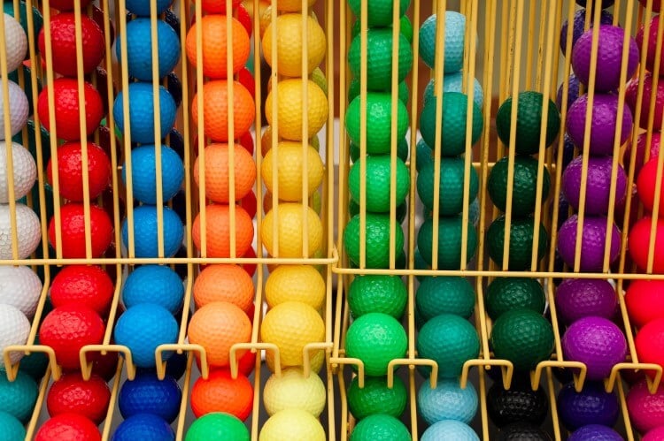 A rack full of colorful golf balls.
