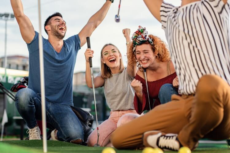 Group of friends enjoying mini golf.