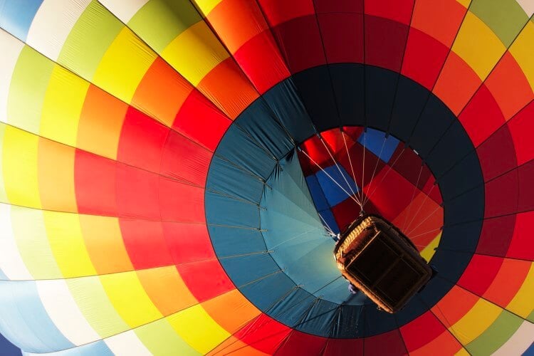 A large, colorful hot air balloon from below. 