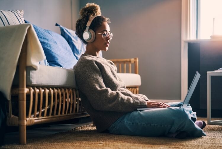 woman on laptop listening to music