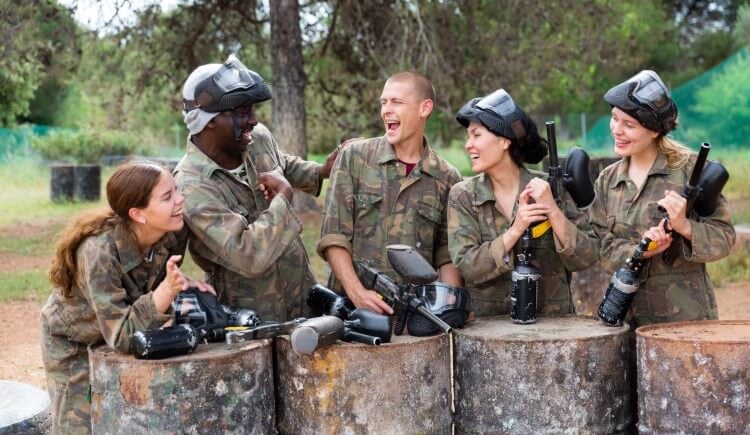 A paintball team laughing between matches.