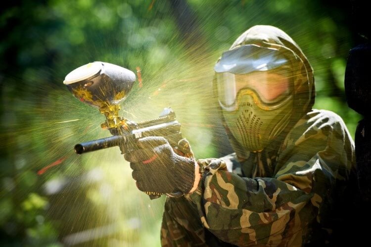 A near miss for a camouflage paintball player.