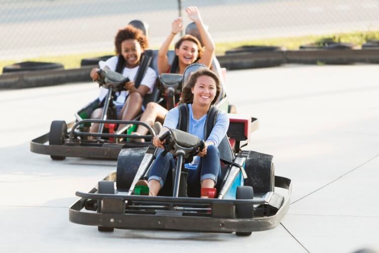 Smiling racers having fun on the karting track.