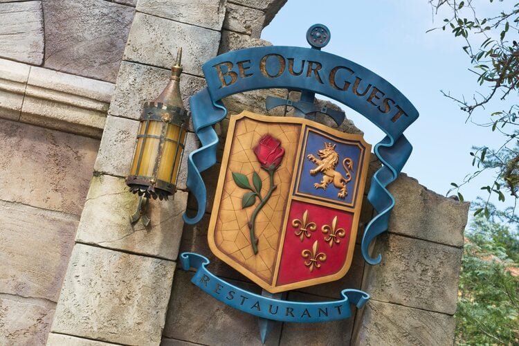 The sign for Be our Guest Restaurant at Magic Kingdom offers a magical character dining experience with the Beast.