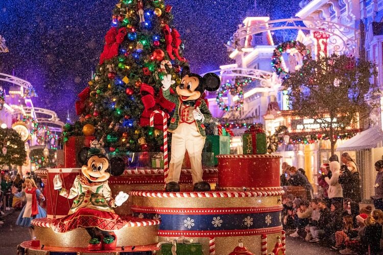 Disney World Christmas event showing Mickey on a festive float during the Christmastime parade. Mickeys Very Merry Christmas Party at Magic Kingdom.