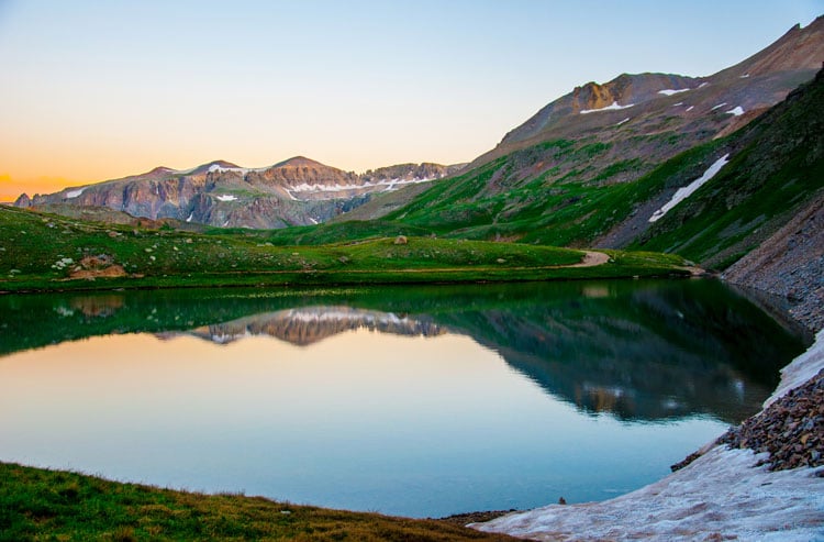 View of still lake and mountains in Colorado - The best places to visit in August