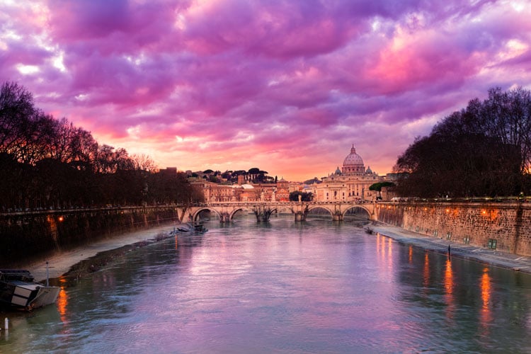 The best places to visit in December - Pink-purple sky over River Tyber in Rome