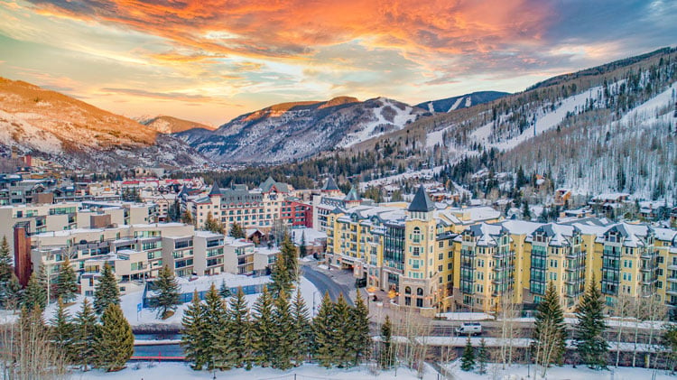 Breckenridge resort with colorful buildings and mountain backdrop for January ski holidays