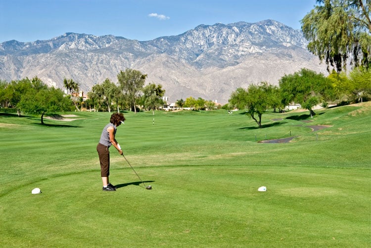 A woman playing golf on a Palm Springs golf course - one of the best places to golf in January