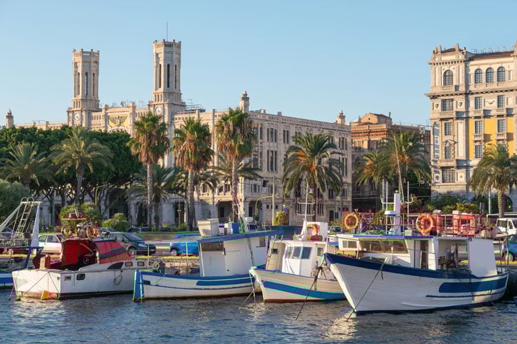 Little fishing boats in a harbor in Sardinia - The best places to visit in June