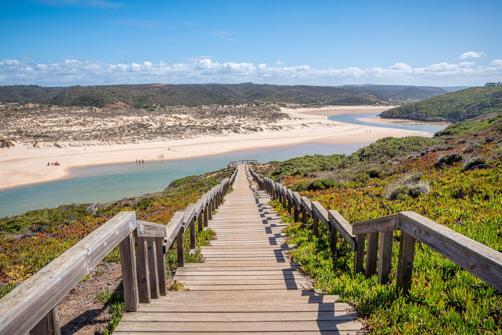 A wooden set of stairs leading down a white sand beach - best places to visit in March