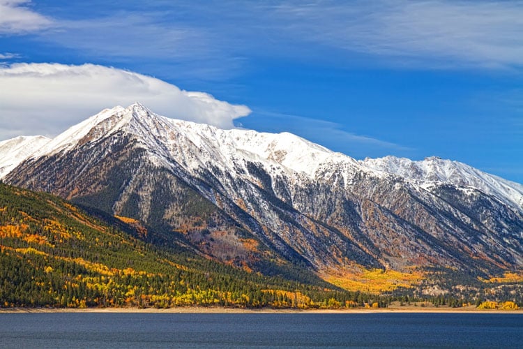 The best places to visit in November- snow capped mountain and lake in Colorado