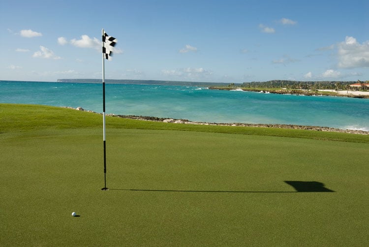 The best places to visit in November- golf course with flag by the sea